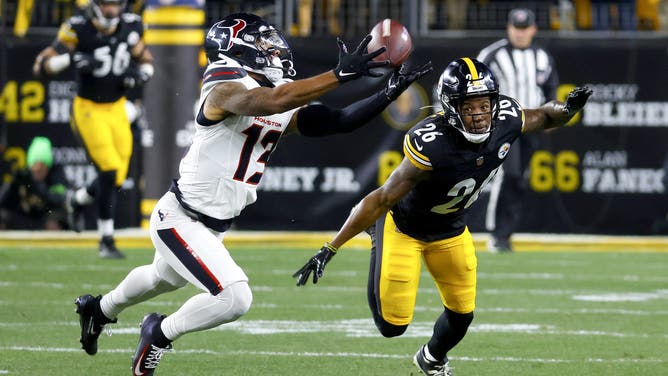 PITTSBURGH, PENNSYLVANIA - JANUARY 12: Christian Kirk #13 of the Houston Texans catches a pass against Brandin Echols #26 of the Pittsburgh Steelers in the first quarter of an NFL wild card playoff game at Acrisure Stadium on January 12, 2026 in Pittsburgh, Pennsylvania.