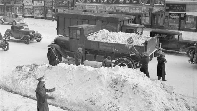 (Original Caption) Department of Sanitation workers clearing Flatbush Avenue in Brooklyn, the morning following New York's worst snow storm since the famed Blizzard of 1888.