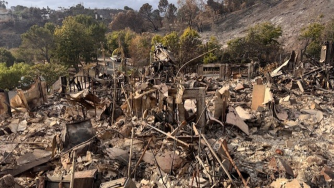 A burnt landscape littered with debris is all that remains of Laura Nativos' home after large flames destroyed it.