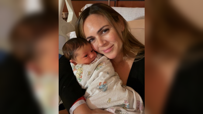 Laura Nativo takes a photo with her newborn baby daughter.