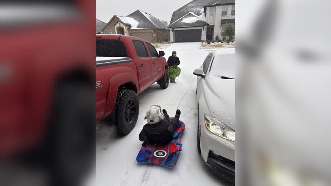 Kids play in the fresh snow in Haslet, TX.