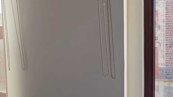 Window shade pull chains swing as a magnitude 6.5 earthquake shakes Mexico City.