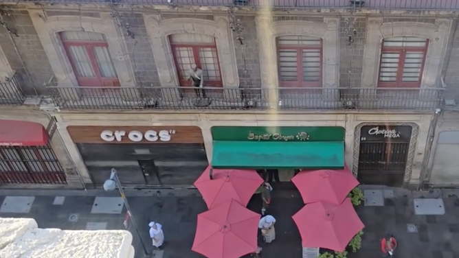 People stand outside a building during an earthquake that shook as far north as Mexico City.