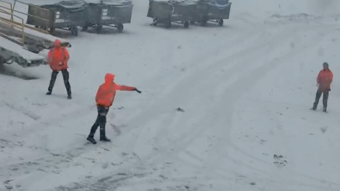 Workers at Amsterdam Airport Schiphol throw snowballs at each other on Jan. 6, 2026.