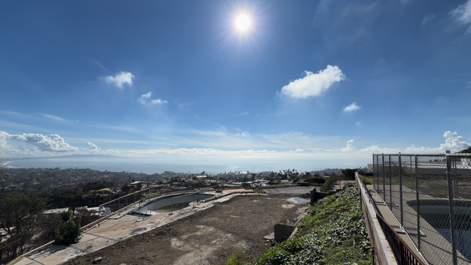 The sun shines bright over the aftermath of the Palisades and Eaton fires one year after the start of the fires in southern California.