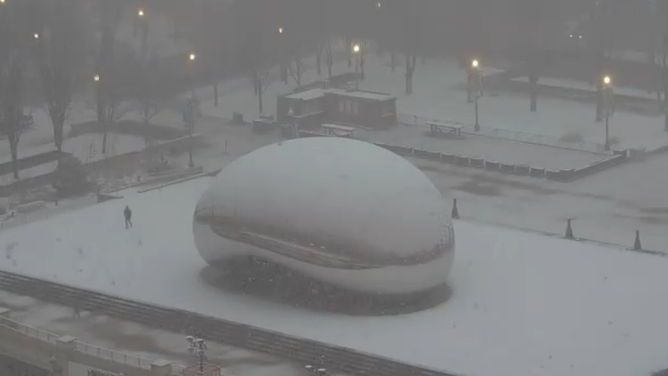 Heavy snow band blankets Chicago skyline Wednesday morning.