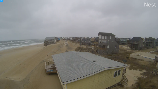 A photo shows snow falling on the beaches of Rodanthe, North Carolina on Jan. 31, 2026 as a powerful nor'easter brews off the Southeastern coast.