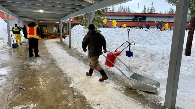 Crews work to clear nearly two million pounds of snow off of Mendenhall River Community School.