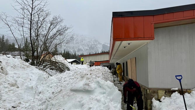 Crews work to clear nearly two million pounds of snow off of Mendenhall River Community School.
