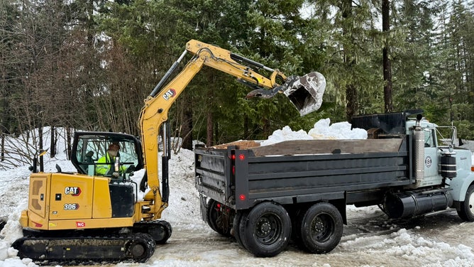 Crews work to clear nearly two million pounds of snow off of Mendenhall River Community School.