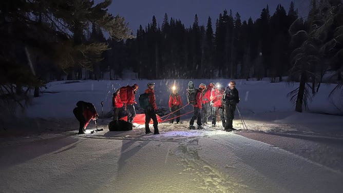 Search and Rescue officials use a sled to extract a hiker suffering hypothermia.