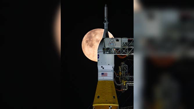 A full Moon is seen shining over NASA’s SLS (Space Launch System) and Orion spacecraft, atop the mobile launcher in the early hours of February 1, 2026.