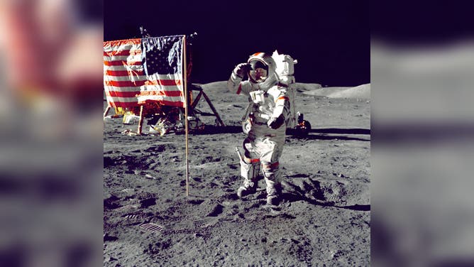 Apollo 17 - NASA, 1972. The Last Man on the Moon: Eugene Cernan poses by the American flag in his A7L spacesuit, December 1972. Artist NASA. 
