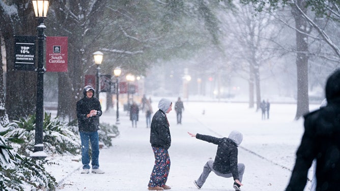 COLUMBIA, SOUTH CAROLINA - JANUARY 31: A student slips and falls on the historic Horseshoe as snow falls at the University of South Carolina on January 31, 2026 in Columbia, South Carolina.