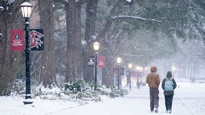 COLUMBIA, SOUTH CAROLINA - JANUARY 31: Students walk across the historic Horseshoe as snow falls at the University of South Carolina on January 31, 2026 in Columbia, South Carolina.