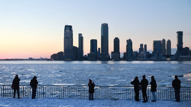 NEW YORK, NEW YORK - JANUARY 29: People watch as ice floats cover part of the Hudson River along the Manhattan shoreline as New York City experiences frigid temperatures following a winter storm over the weekend on January 29, 2026, in New York City. New York received up to a foot of snow in a winter storm that swept through large parts of the country, resulting in numerous deaths, power outages, and accidents.