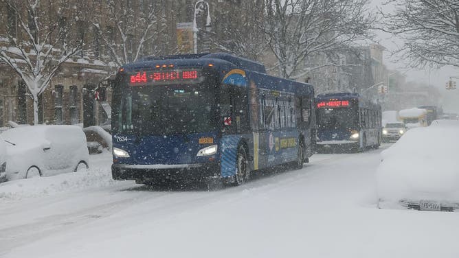 MTA buses during a winter storm in the Brooklyn borough of New York, US, on Monday, Feb. 23, 2026.