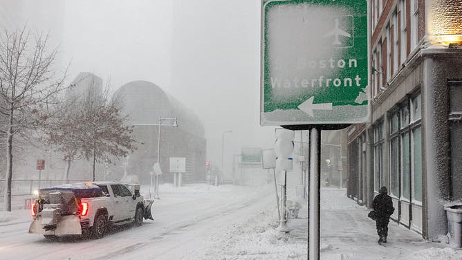 BOSTON, MASSACHUSETTS - FEBRUARY 23: A snowplow passes a snow covered street sign on February 23, 2026 in Boston, Massachusetts.