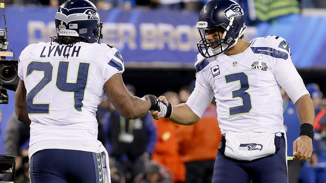 EAST RUTHERFORD, NJ - FEBRUARY 02: Running back Marshawn Lynch #24 of the Seattle Seahawks celebrates his 1-yard touchdown with teammate quarterback Russell Wilson #3 in the second quarter against the Denver Broncos during Super Bowl XLVIII at MetLife Stadium on February 2, 2014 in East Rutherford, New Jersey. 