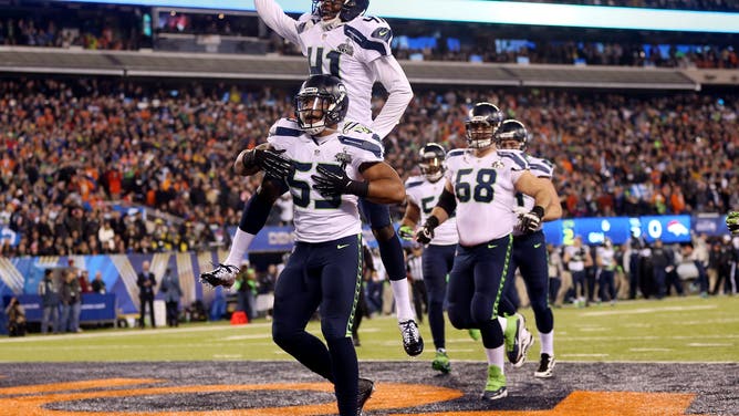 EAST RUTHERFORD, NJ - FEBRUARY 02: Outside linebacker Malcolm Smith #53 of the Seattle Seahawks celebrates his 69-yard touchdown with teammates after intercepting a pass thrown by quarterback Peyton Manning #18 of the Denver Broncos intended for running back Knowshon Moreno #27 in the second quarter during Super Bowl XLVIII at MetLife Stadium on February 2, 2014 in East Rutherford, New Jersey.