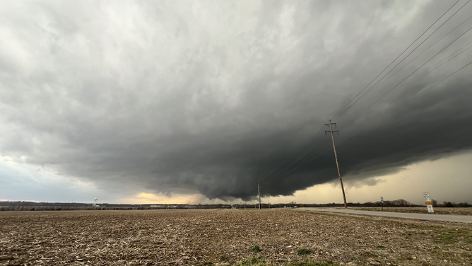A rotating wall cloud with a possible funnel looms just northeast of Carlisle, Indiana Thursday.