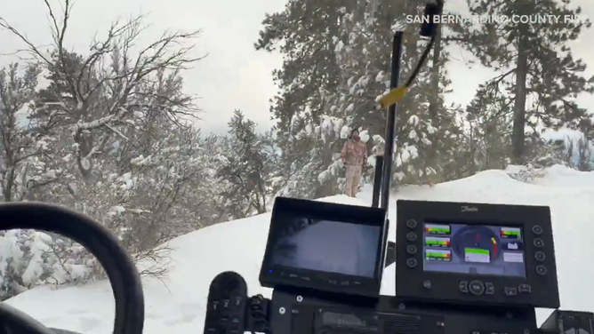 San Bernardino County Fire Department used a specialized heavy rescue vehicle known as a snowcat to save a camper and his dog who were stranded in the San Bernardino Mountains, which have received more than 4 feet of snow since Sunday.