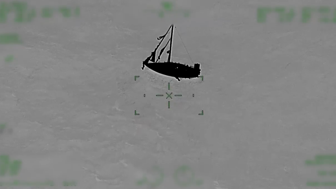 The sailboat rocks against the rough waves.