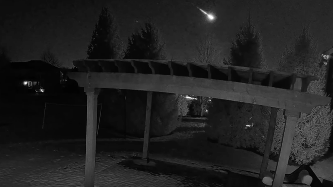Photo shows the fireball shooting through the sky above a pergola in a backyard in Zionsville, Indiana.