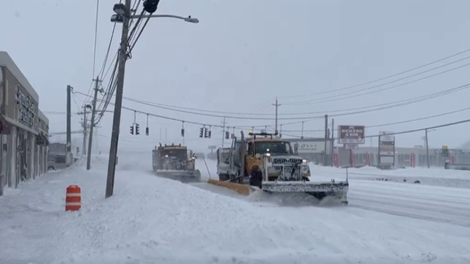 Snow plows clear the roads in Farmingdale, New York.