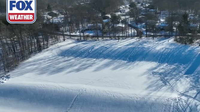 A field is covered in tracks and footprints after people made good of the snow day.