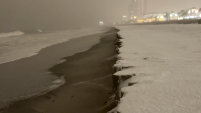 Snow coats the sand in Myrtle Beach, SC from a powerful nor'easter that slammed the Carolinas.