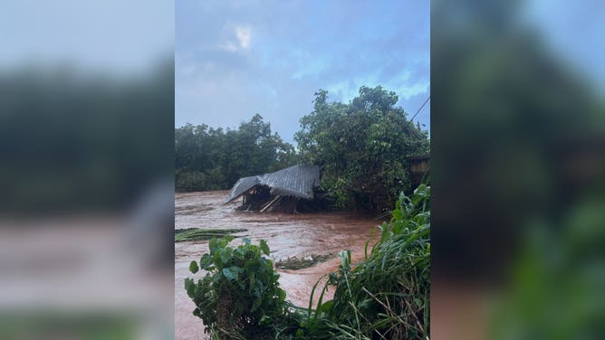 Flooding collapsed a building, pushing into a bridge on O'ahu.