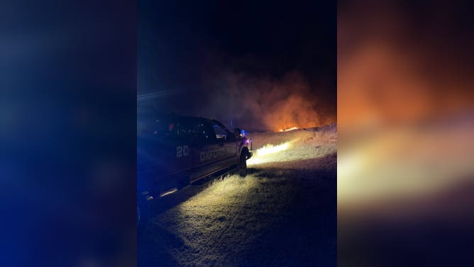 Thick smoke is illuminated by headlights as crews work to battle a wildfire in central Nebraska.