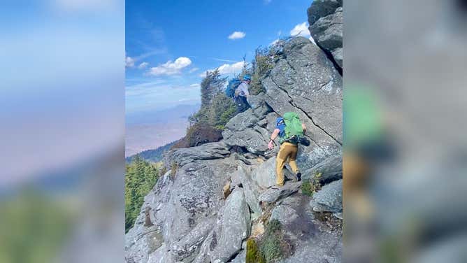 Members of the Linville-Central Rescue Squad navigate through Macrae Peak along the Grandfather Trail in North Carolina to reach an injured hiker.