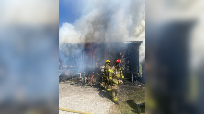 Louisiana firefighters work to fight the flames of a house fire.