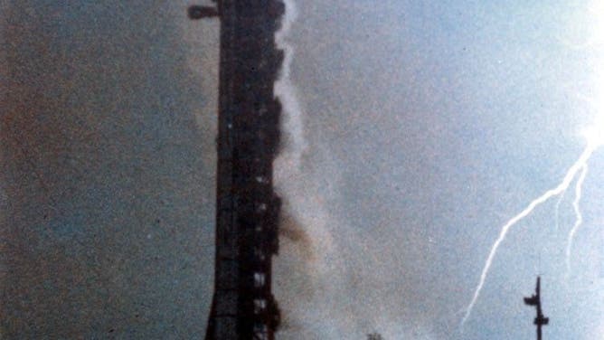 Nov. 14, 1969: View of a lightning bolt during the launch of Apollo 12 from Pad A, Launch Complex 39, Kennedy Space Center. The silhouetted structure is the mobile launch tower.