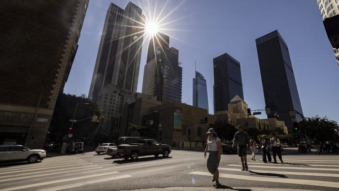 Pedestrians cross a street in downtown Los Angeles on September 4, 2024, as Southern California faces a heat wave.