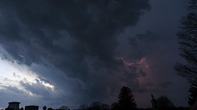 BLOOMINGTON, INDIANA - FEBRUARY 19: Lightning streaks across the sky over west Bloomington as seen from Rosehill Cemetery on February 19, 2026, in Bloomington, Indiana. At least one tornado later touched down, damaging a bank, the animal shelter, and multiple homes and other structures.