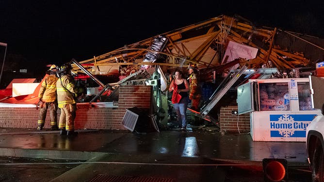 LAKE VILLAGE, INDIANA - MARCH 10: An employee emerges after being rescued from a Family Dollar store destroyed by a tornado on March 10, 2026 in Lake Village, Indiana. The National Weather Service had issued an urgent warning about a large tornado moving through the area, calling it a "life-threatening situation."