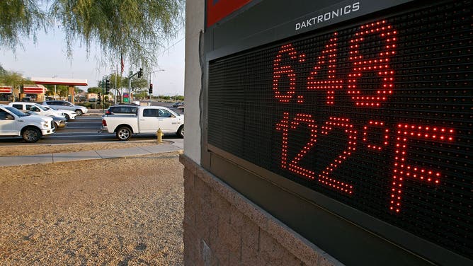 PHOENIX, AZ - JUNE 20: Motorist stop at an intersection where a sign displays the temperature on June 20, 2017 in Phoenix, Arizona.