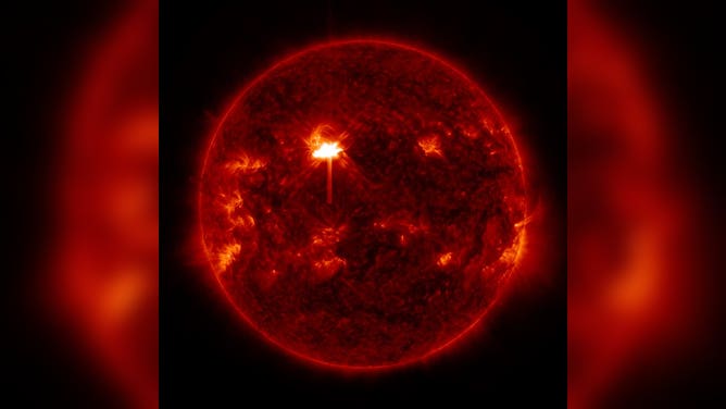 The Sun as seen in ultraviolet light from space by NASA's Solar Dynamics Observatory. The Sun's surface is mottled, with several brighter spots and one very bright spot glowing near the center-left of the disc.