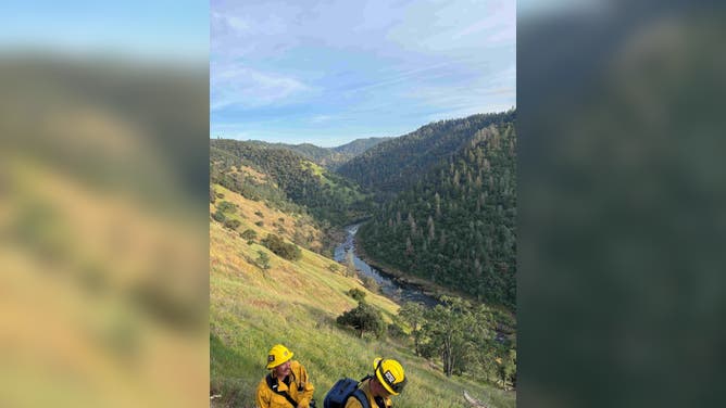 Rescue crews make their way through the steep canyon in California.
