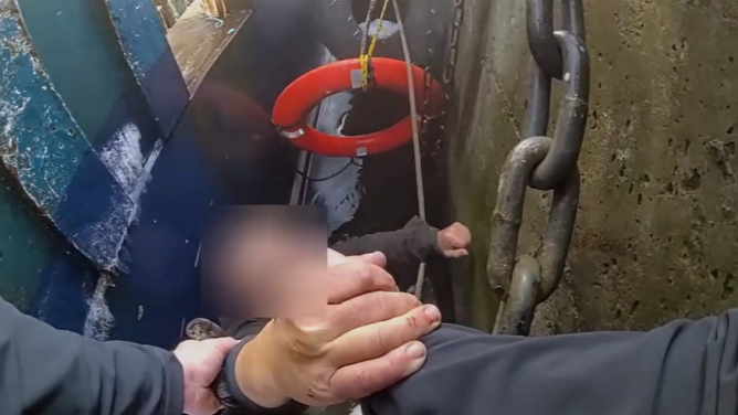 Massachusetts police officers rescued a male fisherman who fell between two boats and into freezing waters on Wednesday.