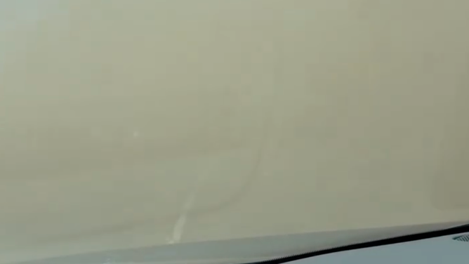 Thick dust blocks the view of a highway in Colorado during a windstorm.