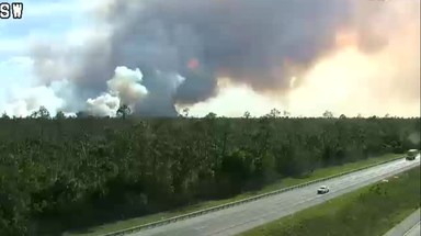 Evacuations remain as brush fire expands near major Florida interstate