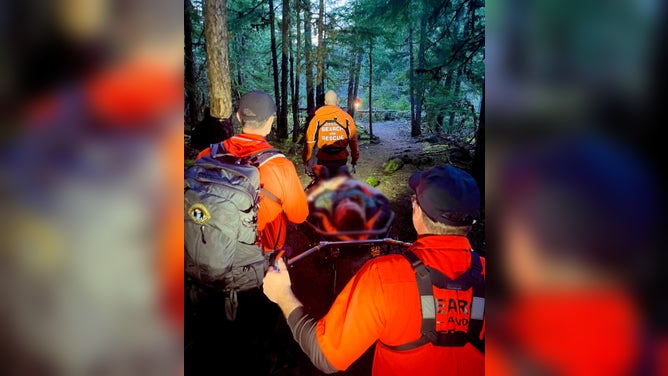 First responders use a wheeled litter to safely extract an injured hiker in Oregon.