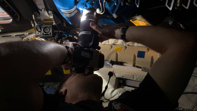 (April 6, 2026) – Astronaut Jeremy Hansen captures an image through the camera shroud covering window 2 of the Orion spacecraft. 
