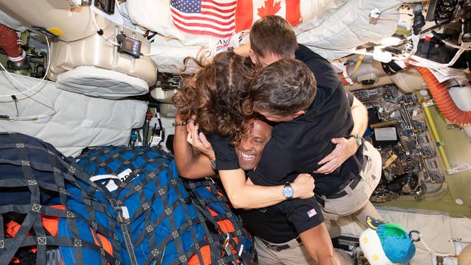 (April 7, 2026) – The Artemis II crew – (clockwise from left) Mission Specialist Christina Koch, Mission Specialist Jeremy Hansen, Commander Reid Wiseman, and Pilot Victor Glover – take time out for a group hug inside the Orion spacecraft on their way home.