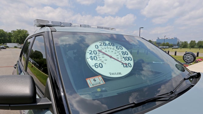 Framingham, MA. - July 7: After 9 mins, the temperature in a police cruiser with the windows shut went from 80 degrees to over 120 degrees as the Mass. State Police and the Animal Rescue League team up inform people about the dangers of leaving a pet in a car on a hot day on July 7, 2021 in , Framingham, MA.