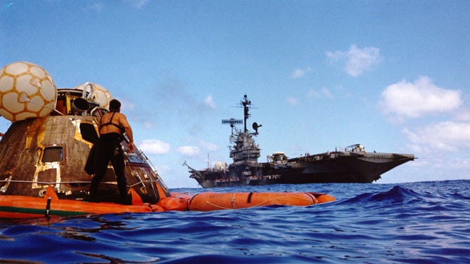 Apollo 17 recovery operations, Pacific Ocean, December 19, 1972. A water-level view of the Apollo 17 Command Module (CM) "America" floating in the sea following splashdown and prior to recovery. The prime recovery ship, the USS Ticonderoga, is in the background. When this picture was taken, the three-man crew of astronauts Eugene A. Cernan, Ronald E. Evans and Harrison H. Schmitt, had already been picked up by helicopter and flown to the deck of the recovery ship. The spacecraft was later hoisted aboard the Ticonderoga. A US Navy UDT diver stands on the flotation collar. Apollo 17 splashdown occurred at 2:24:59 p.m. (EST), Decirca 19, 1972, about 350 nautical miles southeast of Samoa. Artist NASA.